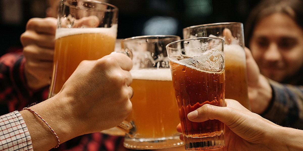 Friends clinking beer glasses together for World Cup